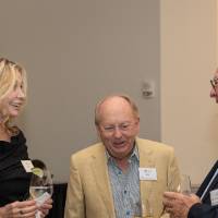 Alan Van Noord, Chuck Cox, and Charlene Dorais standing together and chatting